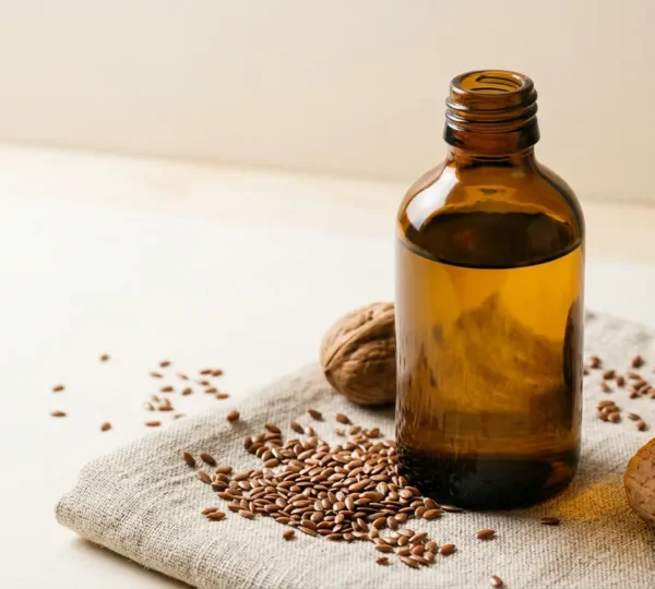 Bouteille opaque d'huile végétale et ingrédients frais sur fond minimaliste évoquant la fraîcheur et la préservation naturelle